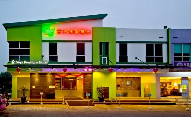 Illuminated green and white frontage of 8 Days Hotel, Taman Impian Emas