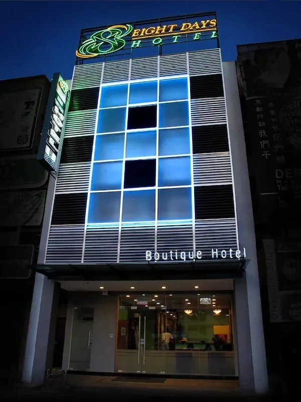 Narrow lit frontage and rooftop signage of 8 Days Hotel, Permas Jaya, at night