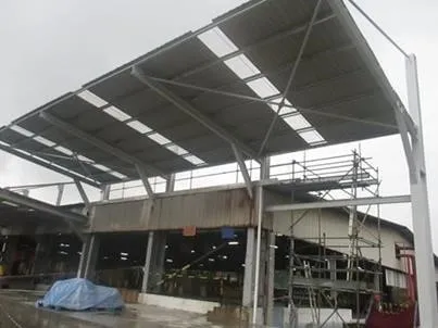 Steel-framed roof extension over the plant building at NGC Energy, Pasir Gudang, scaffolding still in place